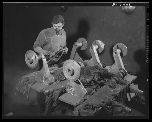 Antiaircraft gun carriage. Paint for protection and for camouflage. This masked operator is painting parts that will be assembled into a thirty-seven-millimeter antiaircraft gun carriage. War program production scene in one of Pennsylvania's heavy industry plants now converted to the production of v