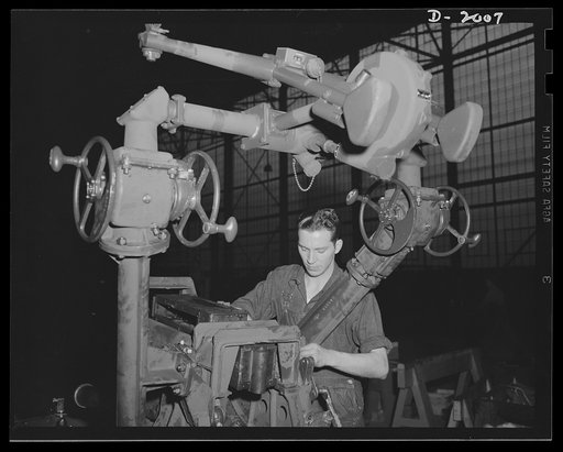 Antiaircraft gun carriage. The elevating mechanism is assembled on a thirty-seven-millimeter antiaircraft gun carriage nearing completion. Care and precision is the watchword in the assembling of these mechanisms. A 300-mile-per-hour target requires a precision instrument to allow the gunner to stay