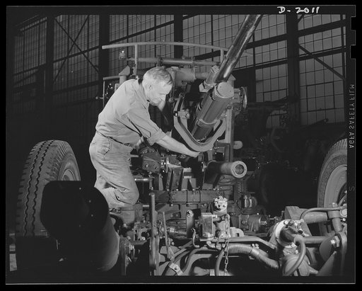 Antiaircraft gun carriage. Final inspection of a thirty-seven-millimeter antiaircraft gun carriage assembly. America's war program requires increased production of these precision instruments of protection, designed to bring down the best-armoured, the fastest-flying enemy aircraft. Production scene