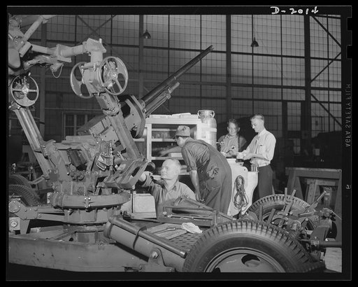 Antiaircraft gun carriage. Time is short! Workers take a few precious minutes for some much needed refreshment from the plant lunch wagon. At the left a thirty-seven-millimeter antiaircraft gun carriage is nearing completion on the assembly line. War program production scene in a Pennsylvania plant.