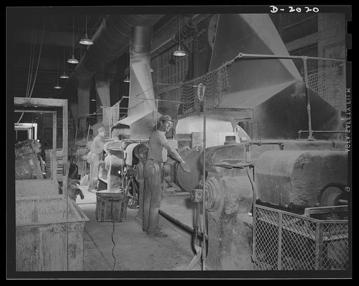 The mill room. Measured batches are delivered to these tire workers, who worked in a room full of batteries of rolling mills. Here, by a rolling process, the rubber is squeezed, pulled, pounded and mixed with the other ingredients until all are blended into a "treated rubber" stock. Firestone (Gener