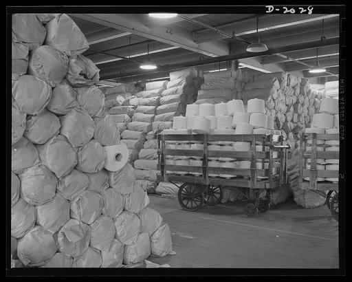 Warehouse view of cord stock. Cord stock as it is received from the mill. This special twist cotton cord comes from southern mills. It differs from other tire cords in that it is woven and twisted by gear-driven machinery instead of belt-driven equipment. Slips and strains of belt-machinery are refl