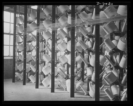 Creel room in action. Two spools are needed for each of the endless cords. As fast as a spool runs out, the auxiliary spool is immediately pulled into service. Each time one of the spools is replaced, the new spool is tied to the end of the spool which is unwinding so that there is never an interrup