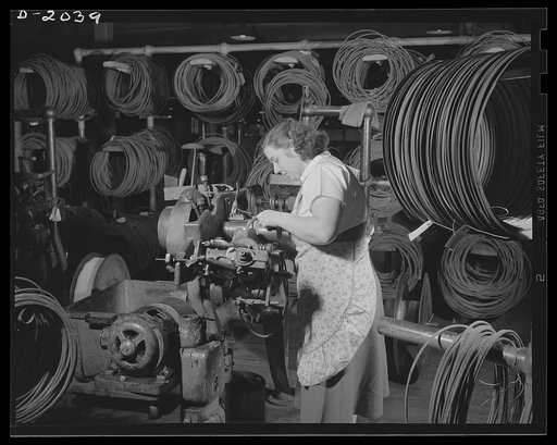 Making the wire beads. Beads which reinforce the tire and hold it firmly on the rim, are made of the highest grade piano wire, and are extremely tough and durable. They must be made to precisely the correct length, and are foiled on the machine illustrated here. Care must be taken that there are no 