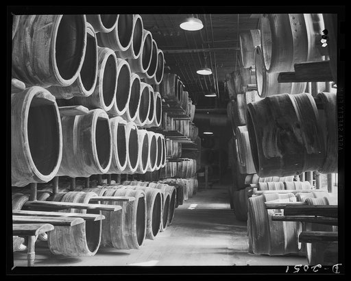 Storage racks for unshaped carcasses. Awaiting the shaping machine, these "finished" carcasses are hung on opened racks, on which they slide easily on and off. Although these carcasses do not look much like tires, they are only two steps away from final completion. Firestone (General) Tires, Akron, 