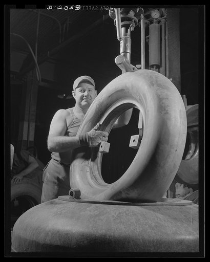 Air bag put into carcass. Under intense hydraulic pressure, this airbag is forced into the casing while it is still in the suction-shaping mold. The bar from the top comes down hard, forces the airbag into a pretzel shape and rams it into the carcass, where the airbag snaps back into shape and fits 