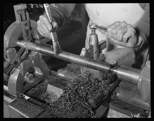Conversion merry-go-round plant. These hands used to turn out merry-go-rounds to gladden the hearts of the nation's children. The carrousel plant in which they work is now engaged in producing war parts on subcontracts from army and navy contractors. Here they are roughing the Acme thread on an extr