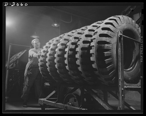 Headed for last cleanup. Six giant truck tires, of the non-directional type are being wheeled in for cleaning and painting. This pattern, developed for the U.S. Army in 1941 is used for field equipment....gives excellent traction in forward or reverse because of the horizontal cleats, yet rides well