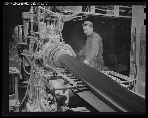 Tubes are extruded. Much as meat is forced through a grinder, tube rubber is forced through this machine and out the opening at the end, which allows an even flow of rubber to make a seamless rubber tube. Firestone (General) Tires, Akron, Ohio