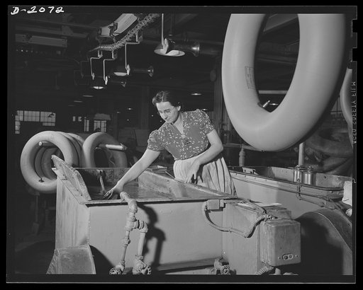 Testing the finished tube before packing. Fully inflated, every tube is tested by immersion in water before being dried, and packed for shipment. Rarely do workers find an imperfect tube, but this extra precaution is taken in every instance--just in case. Firestone (General) Tires, Akron, Ohio