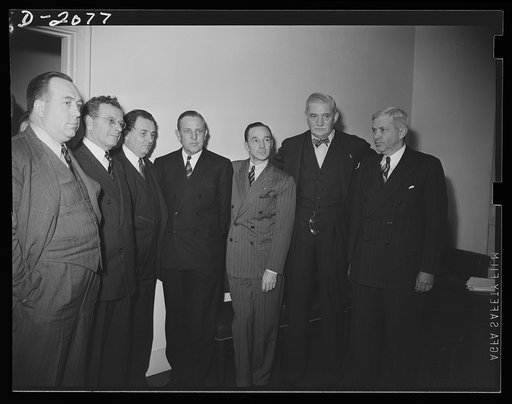 Meeting between officials of the OPM, Army, Navy and representatives of the automobile industry and the automobile unions, to discuss the problems of conversion in automobile plants. Left to right: R. J. Thomas, UAW-CIO (United Auto Workers-Congress of Industrial Organizations) president; Sidney Hil