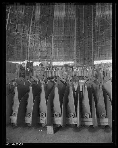 Subcontracting aircraft parts. Full production, twenty-four hours daily, is the schedule on these control surfaces for Martin bombers as well as for many other aircraft parts being turned out in this huge converted airship dock in Ohio. Goodyear, Akron, Ohio