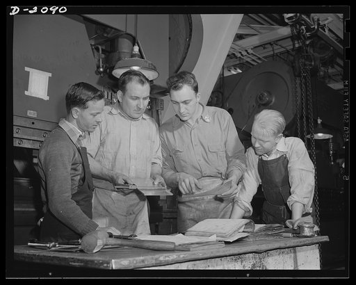 Subcontracting aircraft parts. Just to make certain that there are no errors, workers check each step in the preparation of new parts with the blueprints. This worker is gauging part for a new air-craft sub-assembly, and comparing the measurements with the blueprint. Goodyear, Akron, Ohio