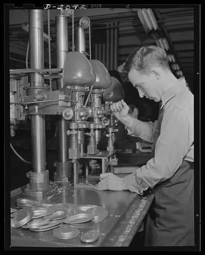 Subcontracting aircraft parts. High speed production of small parts for airplane sub-assembling is expedited by simultaneous use of the three drills shown. This plant has been converted from its former use as an airship dock. Goodyear, Akron, Ohio