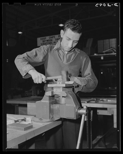 Subcontracting aircraft parts. Handwork is still a vital operation in the production of airplane sub-assembly parts. Metal shaping is the job of this worker at a large Ohio plant. Goodyear, Akron, Ohio