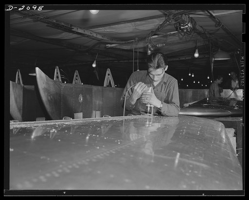 Subcontracting aircraft parts. This gleaming surface is part of an airplane stabilizer being finished by a worker in an Ohio plant. Akron, Ohio