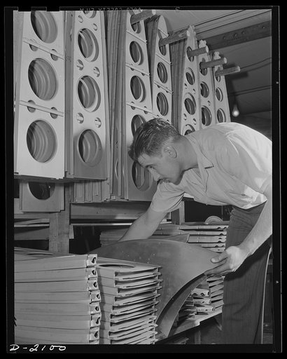 Subcontracting aircraft parts. A complicated system of storing parts for airplane sub-assembly assures workers at an Ohio plant that they will not be held up for parts. Here is a portion of the huge storeroom, with a worker piling small sections where they will be available at a moment's notice. Con