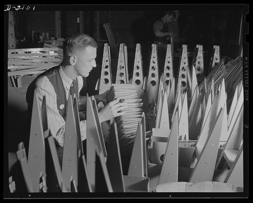 Subcontracting aircraft parts. A complicated system of storing parts for airplane sub-assembly assures workers at an Ohio plant that they will not be held up for parts. Here is a portion of the huge storeroom, with a worker piling small sections where they will be available at a moment's notice. Con