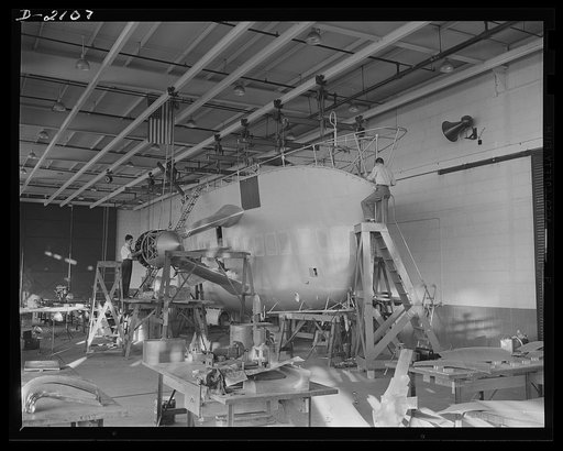 Subcontracting aircraft parts. Nearly ready to take its place in the battle for humanity, this control car for a naval non-rigid airship is receiving the finishing touches at the huge airship dock of an Ohio rubber company. Goodyear, Akron, Ohio