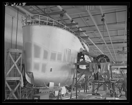Subcontracting aircraft parts. Nearly ready to take its place in the battle for humanity, this control car for a naval non-rigid airship is receiving the finishing touches at the huge airship dock of an Ohio rubber company. Goodyear, Akron, Ohio