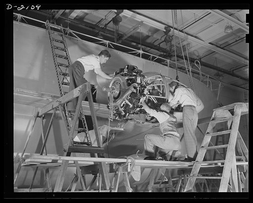 Subcontracting aircraft parts. Nearly ready to take its place in the battle for humanity, this control car for a naval non-rigid airship is receiving the finishing touches at the huge airship dock of an Ohio rubber company. Workers are here installing one of the two powerful motors which provide the