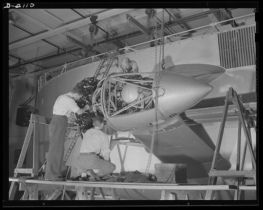 Subcontracting aircraft parts. Nearly ready to take its place in the battle for humanity, this control car for a naval non-rigid airship is receiving the finishing touches at the huge airship dock of an Ohio rubber company. Workers are here installing one of the two powerful motors which provide the