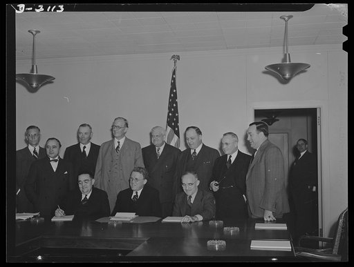 War Labor Board. Here are eleven of the twelve members of the War Labor Board, pictured before their initial meeting on January 16, 1942. Seated are, left to right, vice chairman George W. Taylor, chairman William H. Davis and Frank P. Graham, three of the four public members of the board. The fourt
