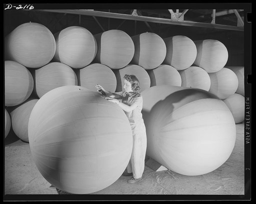 Flotation bag manufacturing. Women workers applying finishing touches to flotation bags used to support airplanes forced down at sea. Goodyear, Akron, Ohio
