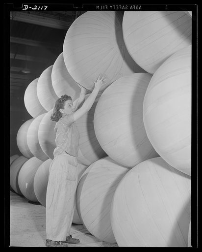 Flotation bag manufacturing. Stack of flotation bags made of rubberized fabric inflated for test purposes, preparatory to deflation for insertion in wings of military airplanes. These bags are used to support planes forced down at sea. Goodyear, Akron, Ohio