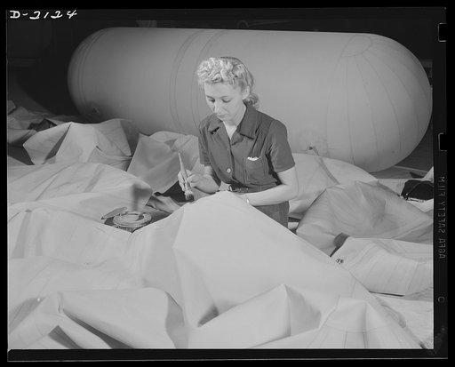 Flotation bag manufacturing. This maze of fabric represents various parts of flotation bags for military aircraft which, when finished, will be like the huge air container shown in background. Goodyear, Akron, Ohio