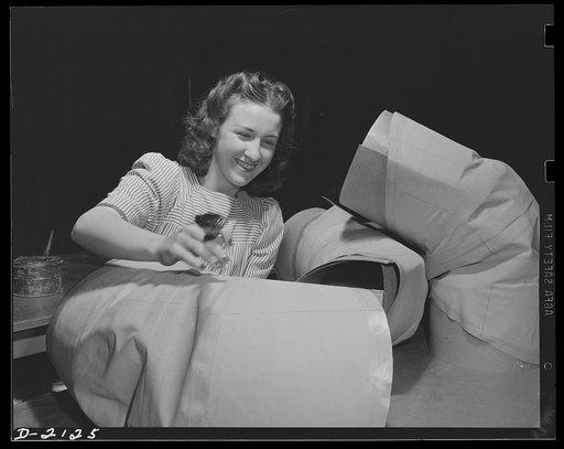 Aircraft lifeboat manufacture. Balloon room worker makes sleeves which look like stove pipe joints, but ultimately will be parts of inflatable rubber boats used in emergency by military fliers. Akron, Ohio