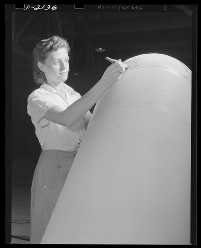 Flotation bag manufacture. Balloon room worker applies cement to airplane flotation bag in balloon room. This bag, easily inflated in a hurry, will help support planes forced down at sea. Goodyear, Akron, Ohio