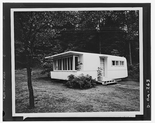 Defense housing. The completely assembled trailer house. Last steps in the assembly were the attaching of the steps and the entrance canopy. The Tenessee Valley Authority (TVA) is experimenting with two types of exteriors. One, shown in the picture, embodies the customary streamline of a trailer. Th