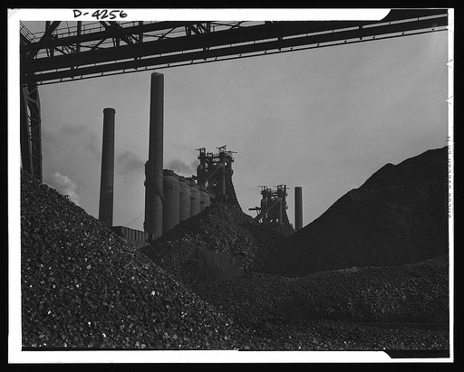 Steel production. The steel industry poised for wartime demands. Huge ore piles await feeding to hungry blast furnaces. Carnegie-Illinois Steel Corporation. Farrell, Pennsylvania