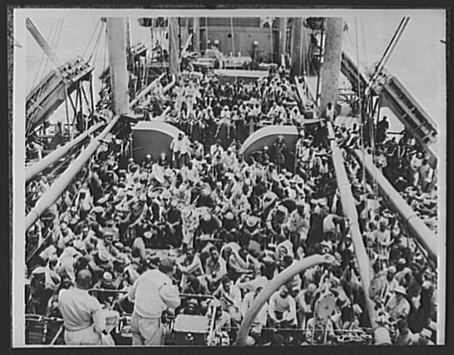 American troops on way to Liberia, Africa. The American soldiers shown here on the deck of a transport, composed chiefly of Negro units, are headed for Liberia, African Negro Republic, after the U.S. government entered into an defense agreement with Liberia. Air bases are being established for the p