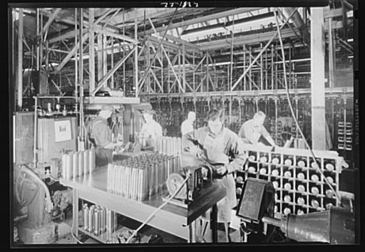 Conversion. Auto parts to artillery shells. Inspection and finishing operations on artillery shells in a converted Midwest auto plant. Workers keep pace with conveyors that were formerly used to speed production of automobile parts