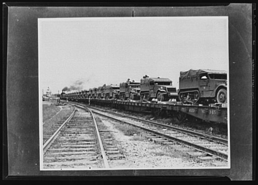 War transportation. Military traffic comes first. One reason why shipments of gasoline and other civilian materials are delayed is because the movement of such army equipment as those half-trac scout cars must have priority over other transportation