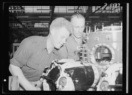 Production. Aircraft engines. Two of the nation's millions of war workers attach cylinder barrels to one of the "green" engines in a huge Midwest aircraft plant. Melrose Park, Buick plant