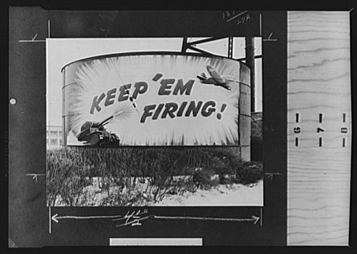 War production drive. "Keep 'em Firing." "Never forget we are at war!" is the working rule of many labor-management committees in charge of war production drives in the plants that are making the country's planes, tanks, guns, and ships. Even the side of a gas tank is utilized in this plant