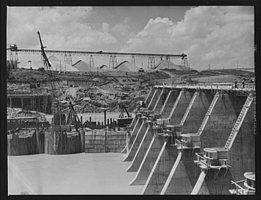 Tennessee Valley Authority power and conservation. Fort Loudoun Dam construction. Downstream face of Fort Loudoun Dam spillway with aggregate storage pile in the background. The new Fort Loudoun Dam is furthest upstream of the TVA's main Tennessee River projects. Scheduled for closure and first stor