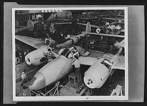 Production. Lockheed P-38 pursuit planes. A new Lockheed P-38 pursuit plane takes form on the production line. The wings and the Allison engines are already in place, and the ship now stands on its own wheels. It still requires many detail jobs before completion, but they are done rapidly under a we