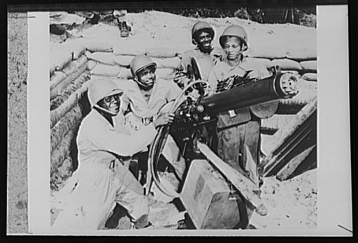 U.S. troops on guard in the New Hebrides. A U.S. Army gun crew, mans a heavy machine gun at a defense employment in the New Hebrides, where British, French and American forces are engaged in joint operations against the Japanese