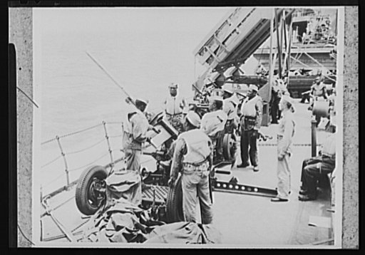 U.S. Negro troops on way to Liberia. As a U.S. Army transport plows through the Atlantic on its way to Liberia, Africa, the Negro crew of a 37mm anti-aircraft gun holds a shipboard practice session. The soldiers, members of a U.S. Army Engineer's unit, were especially interested in Liberia, a Negro 