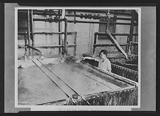 Six stages of fat salvage. Saponification of fats makes glycerine. Glycerine makes explosives and camouflage paints. In this giant soap kettle, in a great industrial plant, fats become soap. When salt is added, the liquid part of this mixture will drop to the bottom of the kettle. That liquid will s