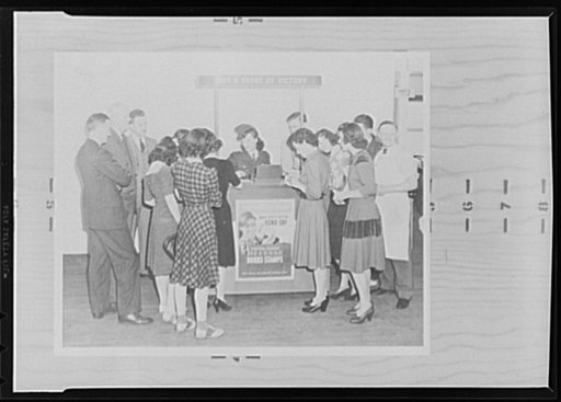 War production drive. A feature of the war production drive in the Westinghouse Lamp Division plant was a portable booth which moved from department to department while a pretty girl, chosen partly because of her ability to wear a uniform well, sold war bonds and stamps and distributed production dr