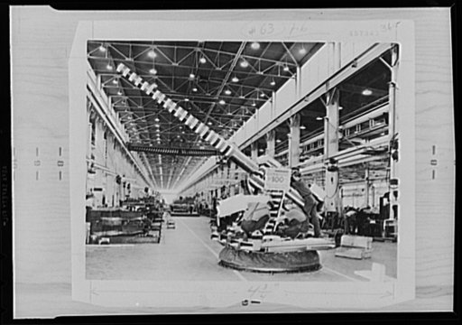 War production drive. It was a great day in the plant of the Northern Pump Company, Minneapolis, when the 100th gun mount was completed. It was decorated with a dummy barrel and festooned in red, white, and blue. Employees staged an impromptu celebration. Many more units have been produced since the