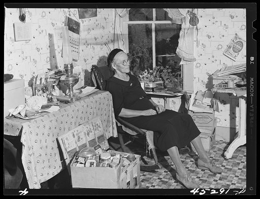 Mrs. Myrtle Higgins of Leraysville, New York, with some of the belongings she has packed preparing to move out of the area being taken over by the Army. Mrs. Higgins has been selling eggs and berries in the town and her son added to her two dollar a week income by working in a junk yard in Watertown
