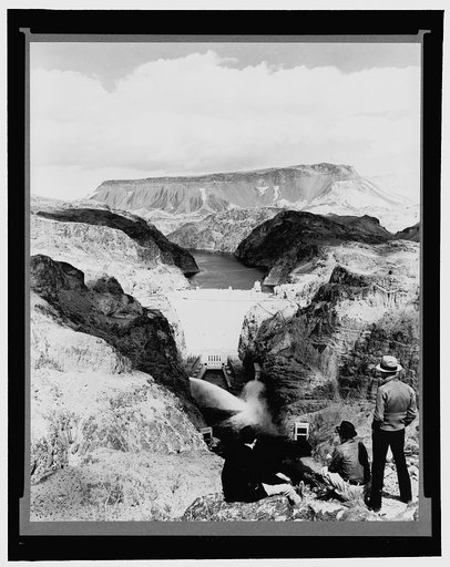 Boulder Dam, between Arizona and Nevada, Apr. 1938. Power plant discharge from two 84-inch needle valves as seen from the high mountain downstream from the dam. Fortification mountain is in the background