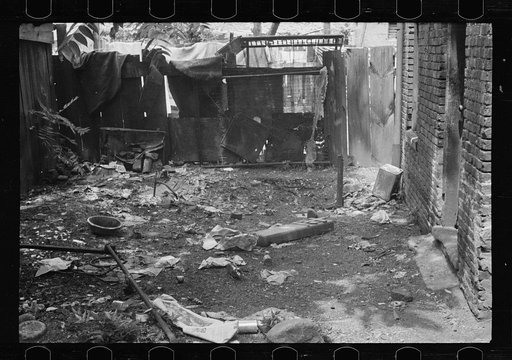 Untitled photo, possibly related to: Negro backyard near Capitol, Washington, D.C. Negro children have just discovered the cameraman and are concerned at his presence