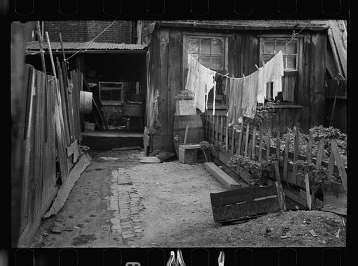 Untitled photo, possibly related to: Front of Negro home near Capitol, Washington, D.C. Interiors of these homes vary little. A chair or two and a table, a bed and perhaps an extra mattress on the floor cares for six to ten people